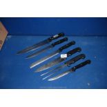 Four cooking knives by Rostferi plus two others including a carving fork.