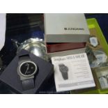 A Junghans Mega solar gentleman's watch with a black face and strap, boxed.
