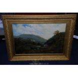 A late 19th c. Oil on canvas in a gilt frame of a Swiss river valley with figures and farm animals.