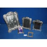 A set of three graduated plus two other white metal photograph Frames.