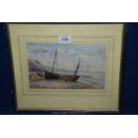 A framed Watercolour of a boat on a beach.