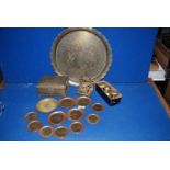 A quantity of brass including circular tray with scalloped edges, set of graduated coasters,