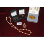 A box of Amber jewellery including, a 9ct gold amber ring, an amber and pearl necklace,