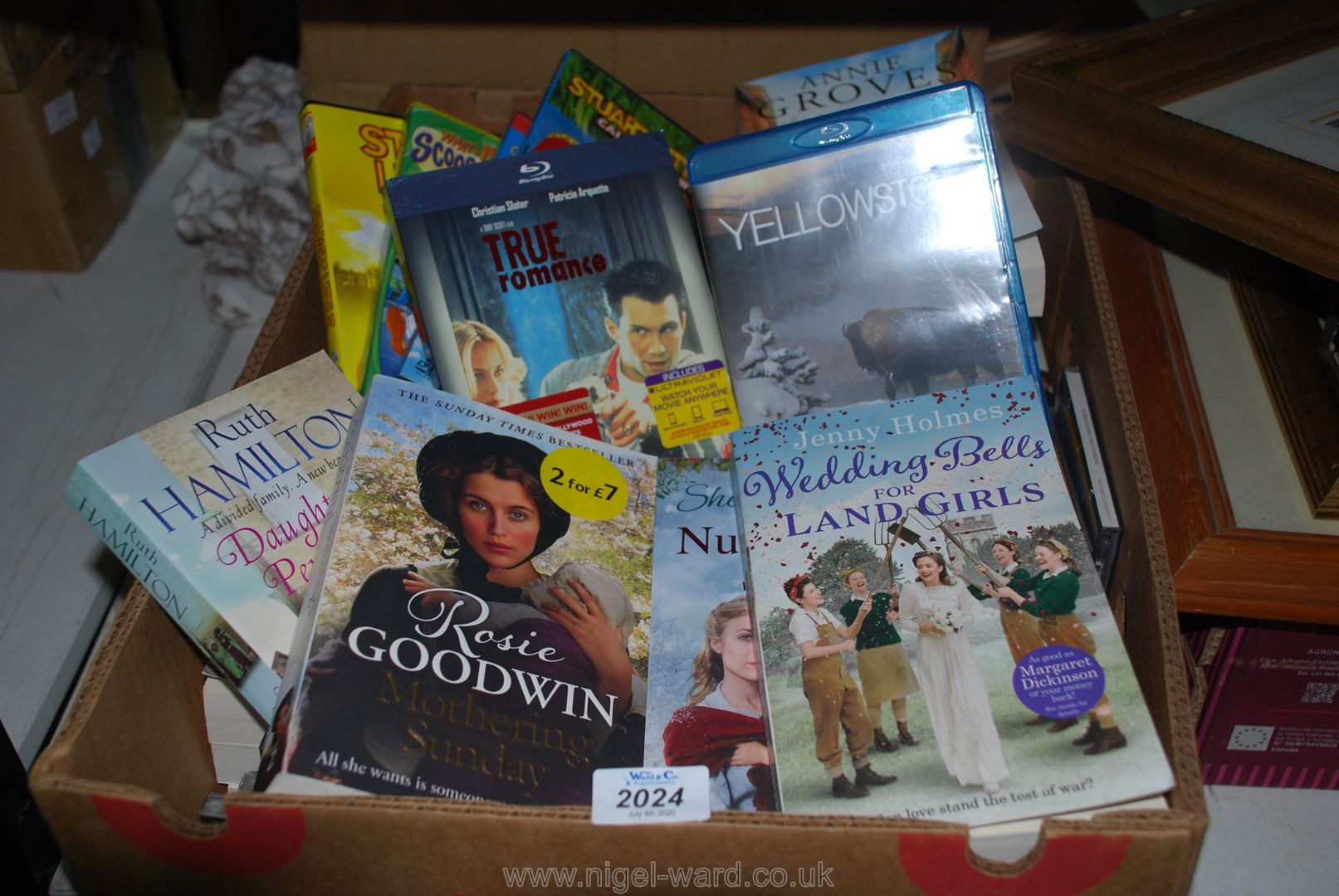 A box of paperback novels and quantity of CD's and DVDs'.