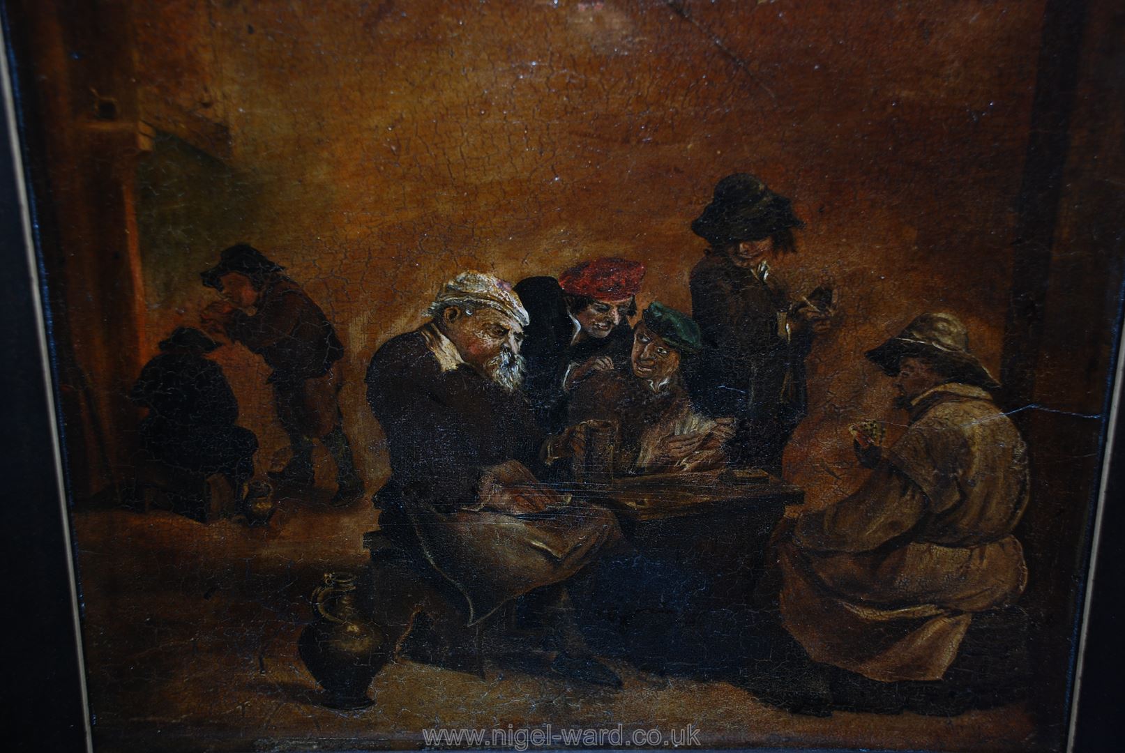 An Oil laid down on panel of topers playing cards in a tavern, in the manner of David Tenners. - Image 2 of 2