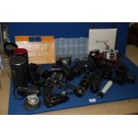 A large quantity of camera lenses, cameras, telescope and an antique pair of 7 x 20 binoculars,