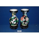 Two Cloisonné vases with white interior and floral decoration on black ground exterior,