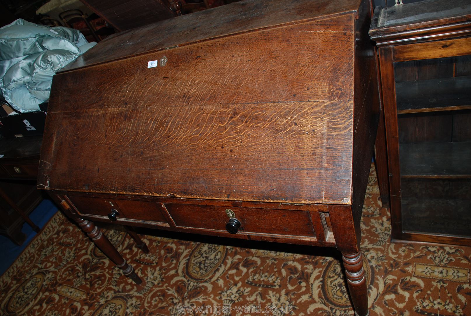 An unusual Victorian Oak writing Desk raised on turned legs and having two frieze drawers,