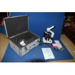 A Specialist Practitioner's Microscope in chrome metal case, with slides and in good condition.