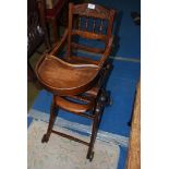 An antique adjustable child's high Chair.