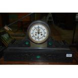 A very heavy black Marble Clock with green stone detail and scroll side panels,