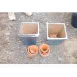 2 x square garden planters and a quantity of clay flowerpots.