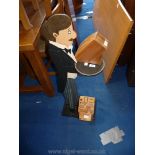 Restaurant menu card holder in the form of a tailored waiter,