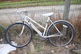 A "Capri Free Spirit" racing bicycle with drop-handlebars and "Shimano Tourney" derailleur type