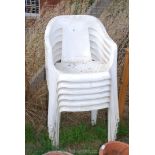 6 x white stacking patio chairs.