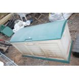 Plastic garden storage box with contents: boxed disabled w.c seat, hose, watering can, etc.