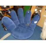 Swivel chair in the form of a cupped hand in blue velour fabric.