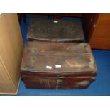 Two metal travel trunks.