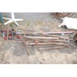 Large quantity of garden tools, pick axes, lopper, hose, steel bars, etc.