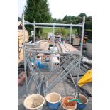 Quantity of 4' x 4' scaffold tower - 10 sections with safety bar boards and foot plates.