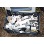Crate of various plastic plumbing items.