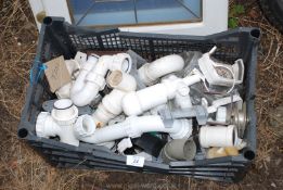 Crate of various plastic plumbing items.