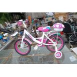 A Girl's pink bicycle with stabilisers.
