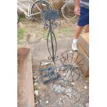 Two metal garden planters, flower arranging stand and basket of metal plant pots.