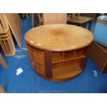 Circular coffee table with shelf sections and cupboards,