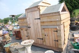 Double hen house with feed store to centre.