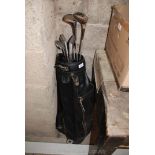 Golf club bag, part set of irons and two woods.