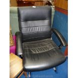 Black faux leather office arm-chair.