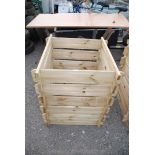 A treated timber compost bin.