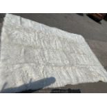 A Flokati 100 % wool rug 340 x 240 cms in cream