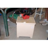 A bathroom laundry box with cork seat and a torch.