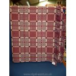 A Tregwynt Welsh wool fringed, reversible bedcover, double size in pink and Burgundy.