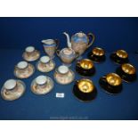 A black and gold cups and saucers and a Chinese Teaset for six with blue and pink bird decoration.
