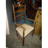 A mixed woods ladderback Elbow Chair having upholstered seat