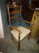 A mixed woods ladderback Elbow Chair having upholstered seat