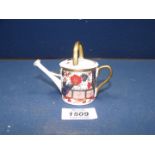 A 20th Century Royal Crown Derby miniature watering can, hand painted in iron red and blue,