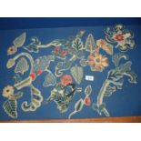 A quantity of antique stumpwork slips/motifs,