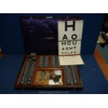 A Theodore Hamblin limited London set of optometrist vision trial equipment in a wooden case,