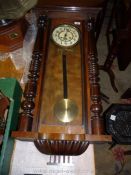 A large wall Clock with plastic film face with Arabic numerals, pendulum, key and finial,