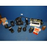 A Minolta camera, boxed Halina pocket camera, flash units. etc.