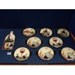 A quantity of Italian style pottery including serving platter shaped as a wine bottle and eight