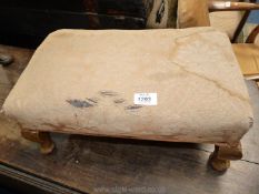 A rectangular beige upholstered (stained) Stool standing on brief cabriole legs,