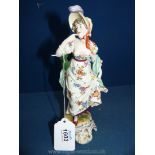 A mid-19th c. Thuringian figure of an elegant young woman; imitation Ludwigsburg mark.