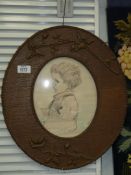A vintage crayon sketch of a young child in decorative oak frame