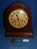 A dome shaped mantle Clock with marquetry edging, with key, no name.