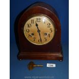 A dome shaped mantle Clock with marquetry edging, with key, no name.